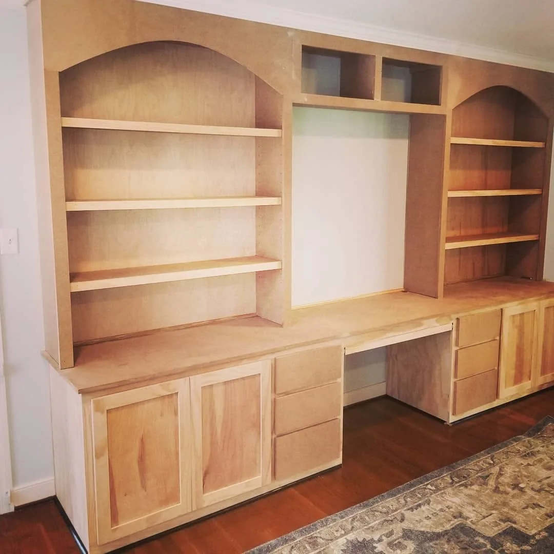 Custom arched built-in cabinetry with desk and shelving