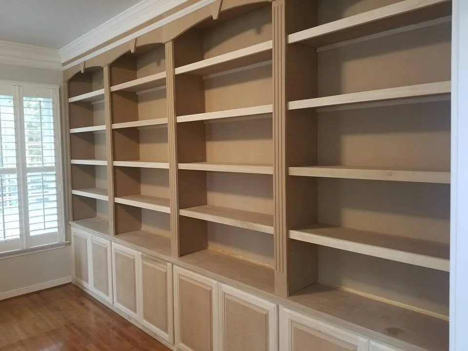 Custom wall-to-wall built-in bookshelves and lower cabinets